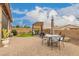 Expansive backyard with a covered patio, dining area, artificial turf, and desert landscaping, ideal for outdoor living at 17797 W Statler Dr, Surprise, AZ 85388