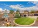 Lush backyard featuring a charming water fountain, well-manicured grass, and a covered patio, perfect for relaxing at 17797 W Statler Dr, Surprise, AZ 85388