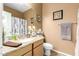 Well-lit bathroom featuring granite counters and modern fixtures at 17797 W Statler Dr, Surprise, AZ 85388