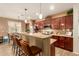 Spacious kitchen with a breakfast bar, rich wood cabinetry, and stainless steel appliances at 17797 W Statler Dr, Surprise, AZ 85388