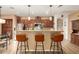 Stylish kitchen with a breakfast bar, granite countertops, and stainless steel appliances at 17797 W Statler Dr, Surprise, AZ 85388