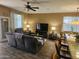 Cozy living room features wood-look tile floors, ceiling fan, and a comfortable seating arrangement for relaxation at 17797 W Statler Dr, Surprise, AZ 85388