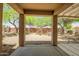 View from covered patio to low-maintenance backyard, neutral rocks, and shade trees at 20007 N Organ Pipe Dr, Surprise, AZ 85374