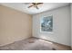 Bedroom with ceiling fan and window showing the front yard at 20007 N Organ Pipe Dr, Surprise, AZ 85374
