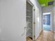 Spacious hallway features a storage closet with wire shelving and access to other rooms at 20007 N Organ Pipe Dr, Surprise, AZ 85374