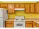 Functional kitchen boasts oak cabinets, an electric stovetop, and ample storage space at 20007 N Organ Pipe Dr, Surprise, AZ 85374
