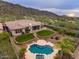 Aerial view of backyard, pool, and lush landscaping of the home nestled near the surrounding mountains at 2106 E Beth Dr, Phoenix, AZ 85042