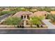 Aerial view of a single-story home featuring desert landscaping, tile roof, and three-car garage at 2106 E Beth Dr, Phoenix, AZ 85042