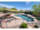 Inviting backyard pool with a safety fence, sunshade, and lounge chairs at 2106 E Beth Dr, Phoenix, AZ 85042