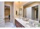 Bathroom featuring double sinks, granite countertops, and access to the bedroom and closet at 2106 E Beth Dr, Phoenix, AZ 85042