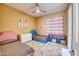 Charming bedroom with twin beds, neutral walls, a ceiling fan, and soft, textured rugs at 2106 E Beth Dr, Phoenix, AZ 85042