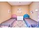 Bright bedroom featuring two beds, a neutral color scheme, and unique decorative wall art at 2106 E Beth Dr, Phoenix, AZ 85042