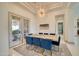 Elegant dining room with stylish lighting, a large table, and blue velvet chairs at 2106 E Beth Dr, Phoenix, AZ 85042