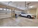 Spacious two-car garage featuring insulated doors, neutral paint, and ample storage space at 2106 E Beth Dr, Phoenix, AZ 85042