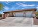 A three-car garage complements this single-story home, with beautiful tile roof and desert landscaping at 2106 E Beth Dr, Phoenix, AZ 85042