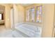 Stunning jacuzzi tub area with mosaic tile detailing and window at 2106 E Beth Dr, Phoenix, AZ 85042