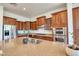 Updated kitchen featuring stainless steel appliances, stone countertops, and wooden cabinetry at 2106 E Beth Dr, Phoenix, AZ 85042