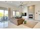 Bright living room features a stone fireplace, large ceiling fan, and glass doors to the outdoor living space at 2106 E Beth Dr, Phoenix, AZ 85042