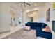 Open living room with a blue sectional sofa, plush ottoman, and modern decor at 2106 E Beth Dr, Phoenix, AZ 85042