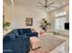 Comfortable living room with blue sofa, neutral rug, and accent lighting, perfect for relaxing at 2106 E Beth Dr, Phoenix, AZ 85042