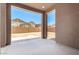 Covered back patio provides a seamless transition to the spacious backyard with a view of neighboring houses at 21838 E Bonanza Ct, Queen Creek, AZ 85142