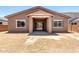 View of the back of the home showcasing sliding glass doors leading to the outdoor covered patio and expansive yard at 21838 E Bonanza Ct, Queen Creek, AZ 85142