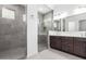 Modern bathroom features a tiled walk-in shower and double vanity at 21838 E Bonanza Ct, Queen Creek, AZ 85142