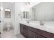 Modern bathroom with dual sinks, vanity, and bright lighting offers a luxurious and convenient space at 21838 E Bonanza Ct, Queen Creek, AZ 85142