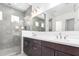 Bathroom with a tiled shower, dual vanity, and recessed lights at 21838 E Bonanza Ct, Queen Creek, AZ 85142