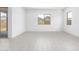 Empty bedroom with sliding glass door and windows, featuring tile flooring at 21838 E Bonanza Ct, Queen Creek, AZ 85142