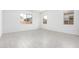 Bright, empty bedroom with three windows and neutral tile flooring at 21838 E Bonanza Ct, Queen Creek, AZ 85142
