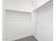 A clean and bright closet provides ample storage space with wooden rods and bright white walls at 21838 E Bonanza Ct, Queen Creek, AZ 85142