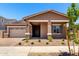 Charming single-story home featuring a well-maintained front yard, covered porch, and neutral color palette at 21838 E Bonanza Ct, Queen Creek, AZ 85142