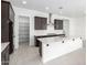 Modern kitchen featuring dark cabinetry, stainless steel appliances, and an expansive island at 21838 E Bonanza Ct, Queen Creek, AZ 85142