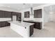 Stylish kitchen with dark cabinets, stainless steel hood, white countertops, and modern fixtures at 21838 E Bonanza Ct, Queen Creek, AZ 85142