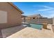 Large backyard with stone patio, pool and exterior of the home at 2318 W Kristina Ave, San Tan Valley, AZ 85144