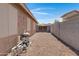 Fully fenced backyard features stone landscape and filtration equipment at 2318 W Kristina Ave, San Tan Valley, AZ 85144