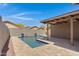 Inviting backyard with pool, covered patio, and well-maintained desert landscaping at 2318 W Kristina Ave, San Tan Valley, AZ 85144