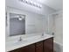 Bathroom featuring a double sink vanity, large mirror, and shower and tub combo at 2318 W Kristina Ave, San Tan Valley, AZ 85144