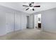 Spacious bedroom featuring neutral carpeting, a ceiling fan, and closet at 2318 W Kristina Ave, San Tan Valley, AZ 85144