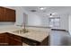 The kitchen features granite countertops, a stainless steel sink, and wood cabinets at 2318 W Kristina Ave, San Tan Valley, AZ 85144