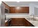 Kitchen with granite counters, stainless appliances, tile flooring and wood cabinetry at 2318 W Kristina Ave, San Tan Valley, AZ 85144