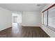 Spacious living area featuring neutral paint, hard wood flooring, and lots of natural light at 2318 W Kristina Ave, San Tan Valley, AZ 85144