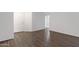 Open living space featuring neutral paint, hardwood floors, and a white front door at 2318 W Kristina Ave, San Tan Valley, AZ 85144