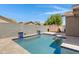 Wonderful backyard pool with travertine pavers, blue tile accents, and block fencing at 2318 W Kristina Ave, San Tan Valley, AZ 85144