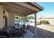 Covered patio with outdoor dining set, and view of the pool in the landscaped backyard at 238 W Marco Polo Rd, Phoenix, AZ 85027
