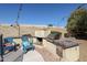 Exterior backyard shot of the outdoor kitchen with barbecue and blue patio chairs at 238 W Marco Polo Rd, Phoenix, AZ 85027