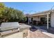 Exterior of outdoor kitchen with gas grill, storage and patio with dining furniture at 238 W Marco Polo Rd, Phoenix, AZ 85027