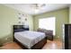 Bright bedroom featuring laminated wood floors, ceiling fan and a window with natural light at 238 W Marco Polo Rd, Phoenix, AZ 85027