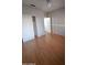 Cozy bedroom with light-colored walls, ceiling fan, and wood-look laminate flooring at 238 W Marco Polo Rd, Phoenix, AZ 85027
